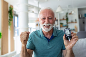 Diabetes Care. Blood sugar testing at home. Checking Blood Sugar Level At Home. Diabetic Checking Blood Sugar Levels. Senior man checking blood sugar level by glucometer and test stripe at home