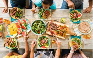 A family sits down to a a delicious, healthy dinner where kids eat vegetables
