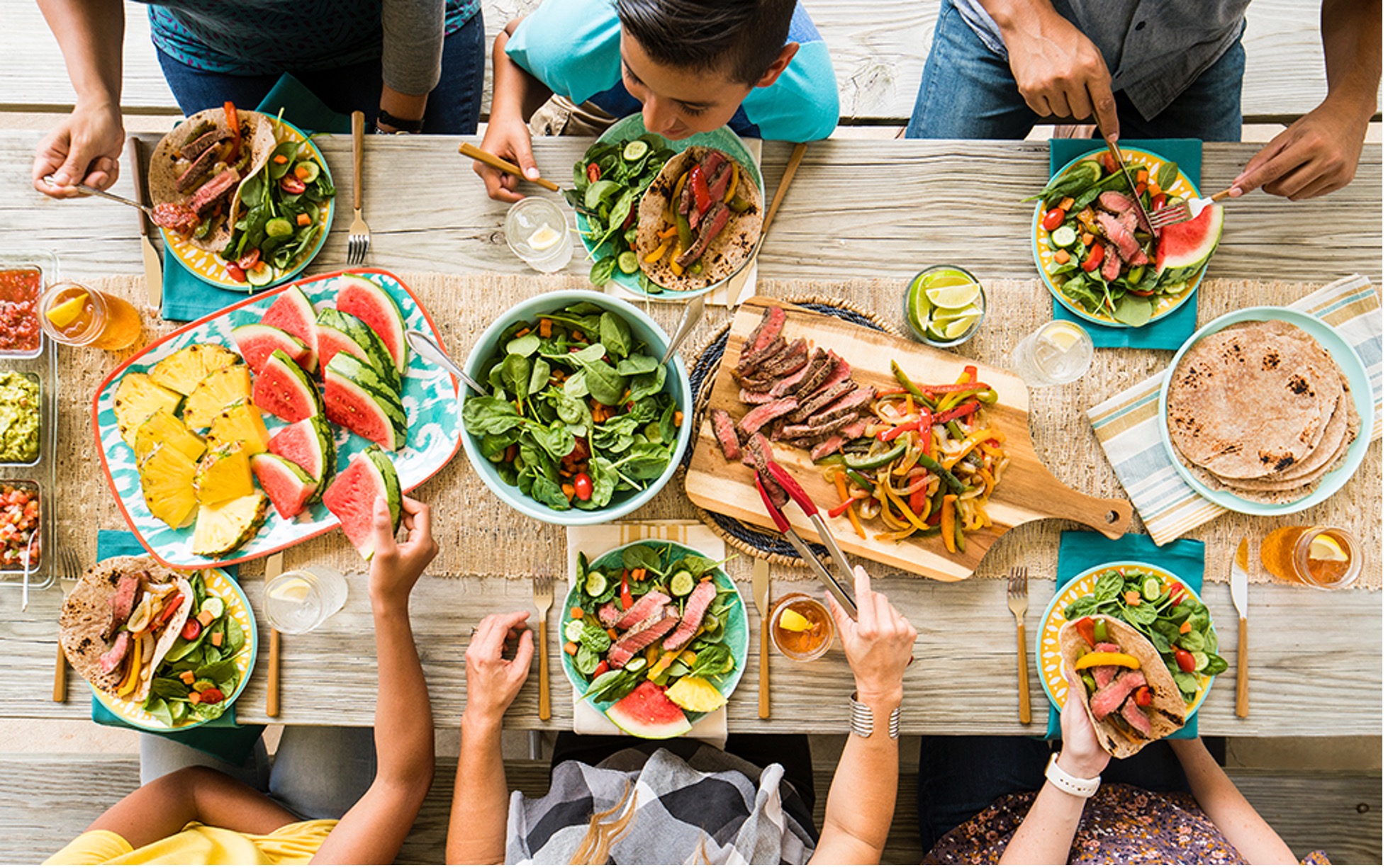 A family sits down to a a delicious, healthy dinner where kids eat vegetables