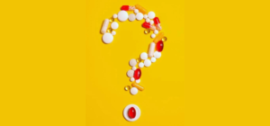 a question mark made of pills on a yellow background