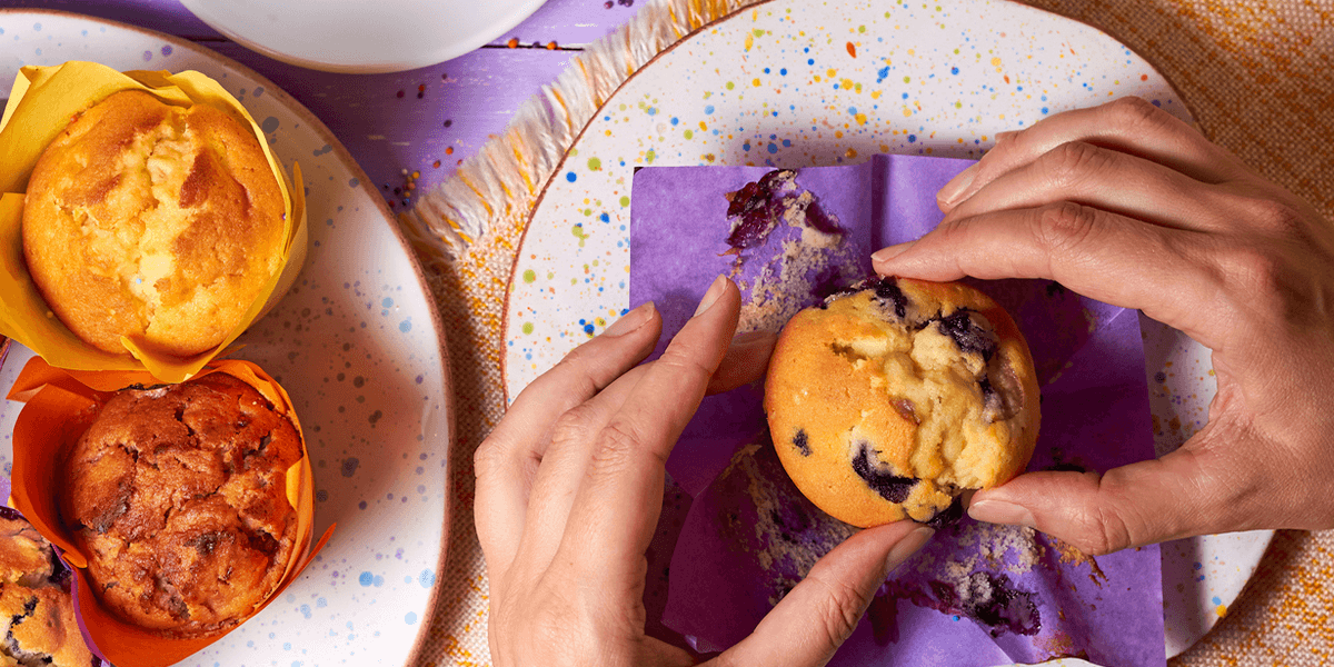 a blueberry muffin on a speckled plate