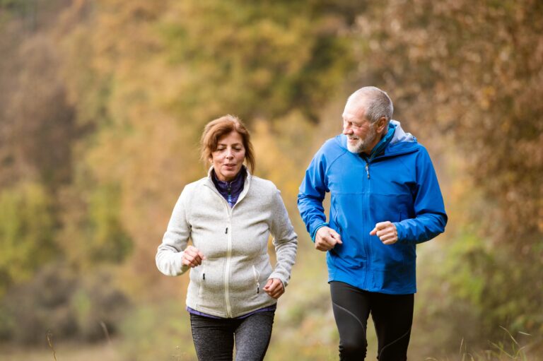 senior couple running outdoors together