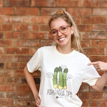 a woman wearing a t-shirt that says asparagus tips
