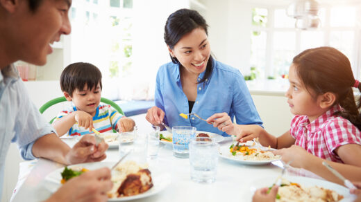 Asian Family Sitting At Table Eating Meal Together after meal planning